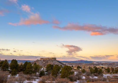 Photo of Blue Skies, Pink, Yellow and Orange Clouds over Castle Rock in Autumn