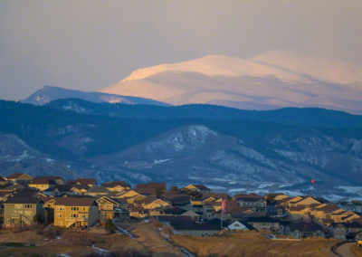 New Home Community in Castle Rock with Snow Covered Mt Evans Above at Sunrise