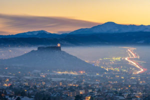 Photo of Illuminated Castle Rock Star and Pikes Peak with Haze and Fog