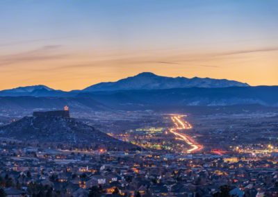 Stunning Wide Panoramic Photo of Illuminated Castle Rock Star and Pikes Peak with Cars on I-25