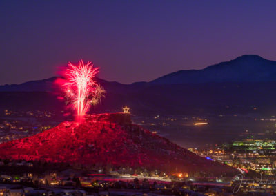 Close up of Fireworks Show over the Rock in Castle Rock Colorado with Majestic Pikes Peak in Background at the Annual Starlighting Ceremony