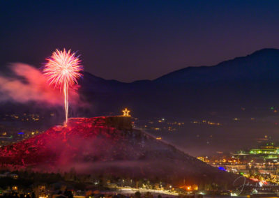 Night Sky Glows Purple with Fireworks over the Rock in Castle Rock Colorado with Pikes Peak in Background at the Annual Starlighting Ceremony