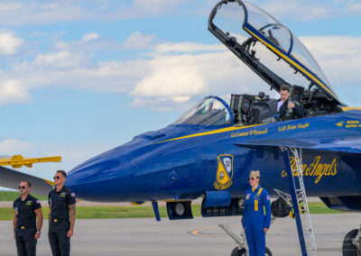 Honored Second Seat Team Member Removing Flight Gear While Crew and Lieutenant Commander Amanda Lee Stand at Attention