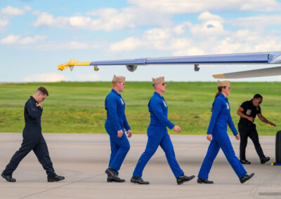 Blue Angle Pilots and Honored Team Member make their way to their Post Flight Debriefing